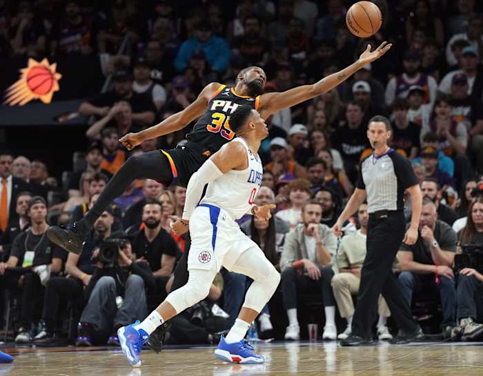 LA Clippers guard Russell Westbrook fouls Phoenix Suns forward Kevin Durant.